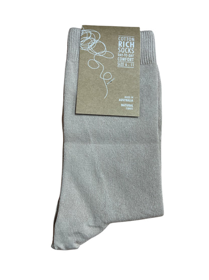 Beige sock with a label on a white background