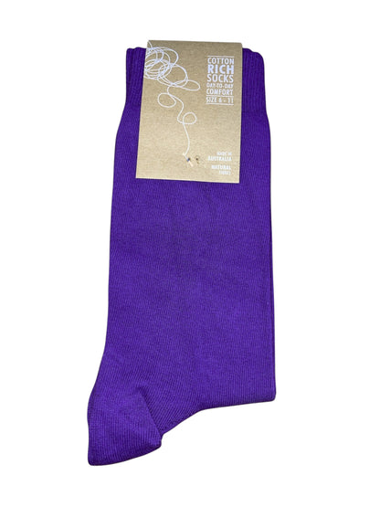 Purple sock with a beige label on a white background
