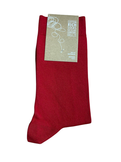 Red sock with a beige label on a white background